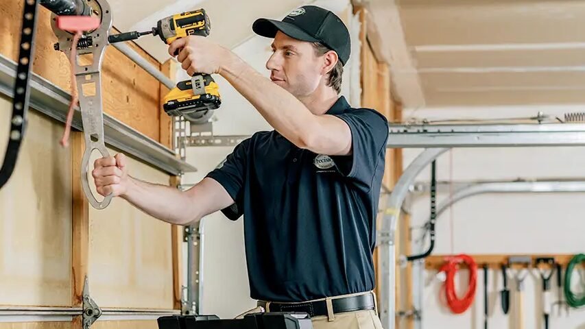 Technician performing a professional garage door inspection to ensure safety and efficiency.