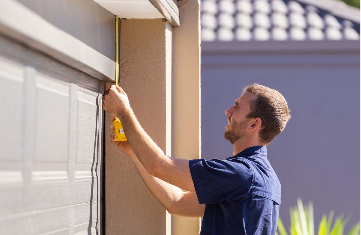 Expert performing torsion spring repair safely on a garage door in The Woodlands