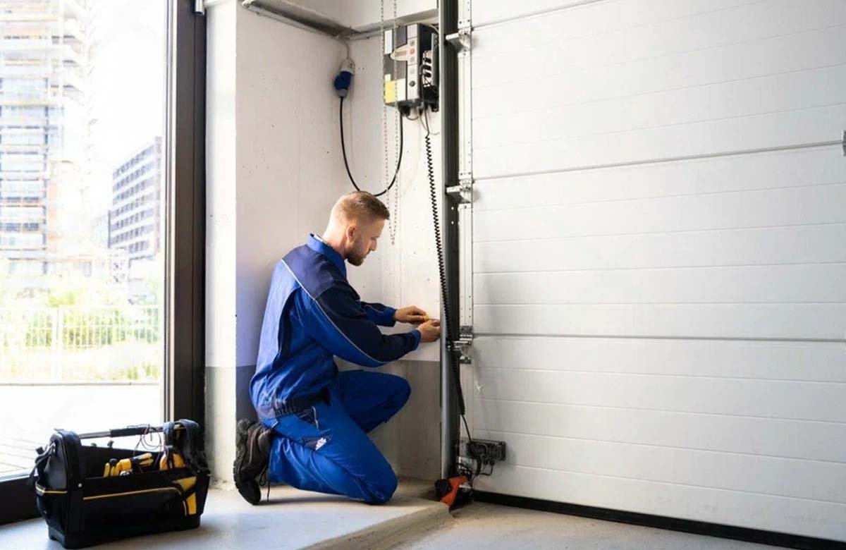 Expert performing torsion spring repair safely on a garage door in The Woodlands