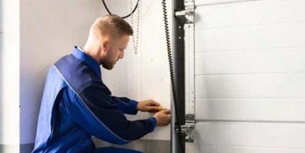 Expert performing torsion spring repair safely on a garage door in The Woodlands